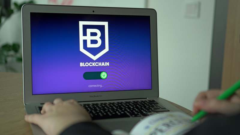 Laptop displaying Solidity code and Ethereum block explorer interface, with digital circuit pattern background