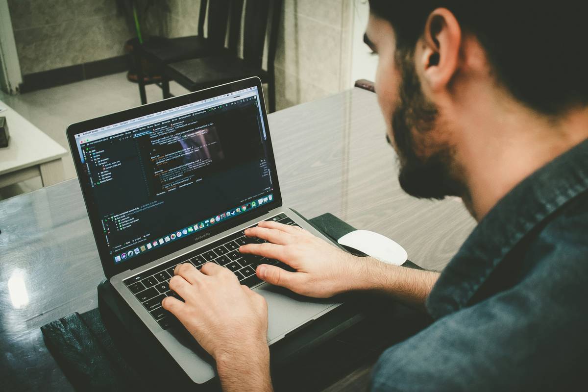 what is a blockchain developer showing laptop with Solidity code, Ethereum block explorer, and terminal logs side-by-side
